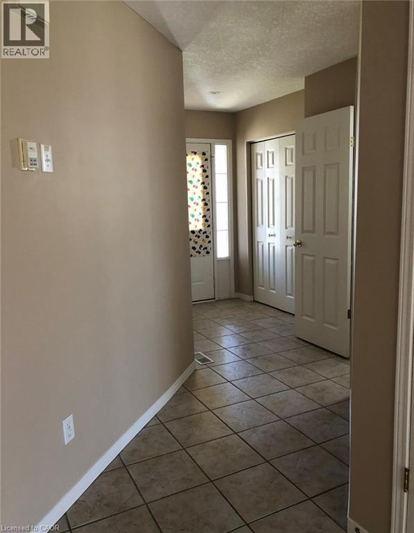 Entryway featuring ceramic tile flooring, light tan wall paint, recessed lighting, and white bi-fold doors - 350 Havendale Crescent, Waterloo, ON - Indoor Photo Showing Other Room