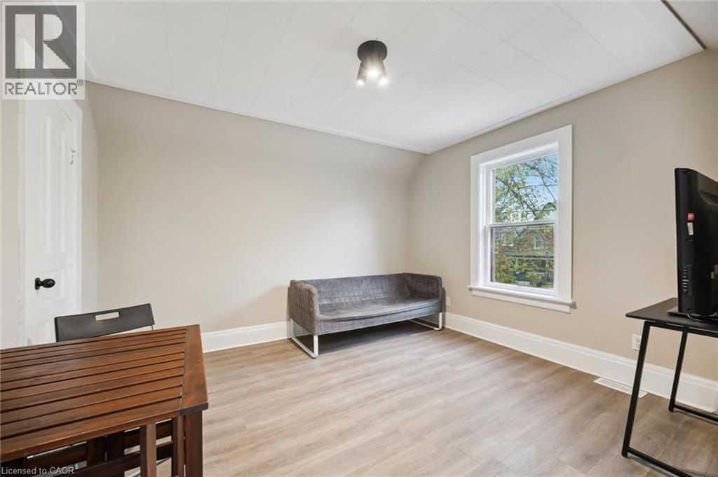 Light-toned wood-finish flooring complements neutral wall tones - 15 Gordon Avenue, Kitchener, ON - Indoor
