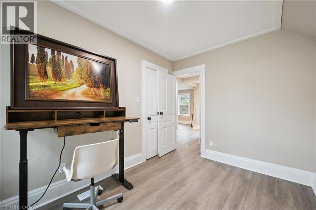 Light-toned walls with contrasting white trim, wood-finish flooring, and a white ceiling with recessed lighting - 15 Gordon Avenue, Kitchener, ON - Indoor Photo Showing Other Room