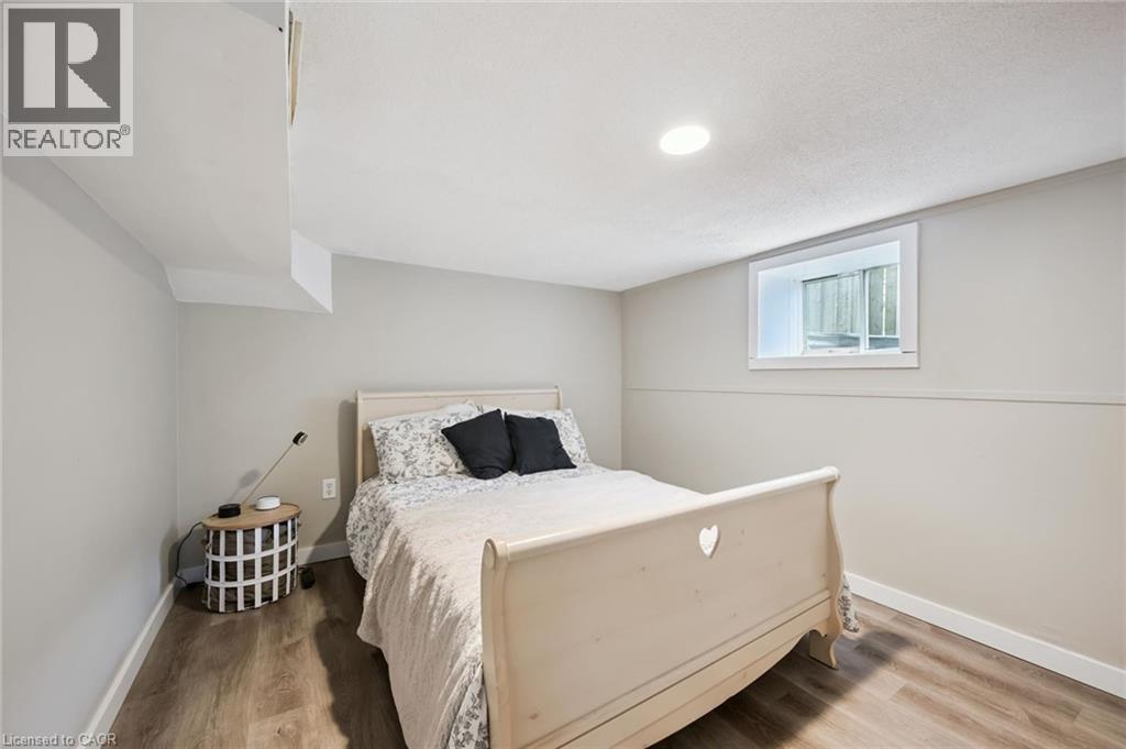 Inviting room featuring wood-finish flooring, recessed ceiling lighting, and a white-trimmed window - 15 Gordon Avenue, Kitchener, ON - Indoor Photo Showing Bedroom