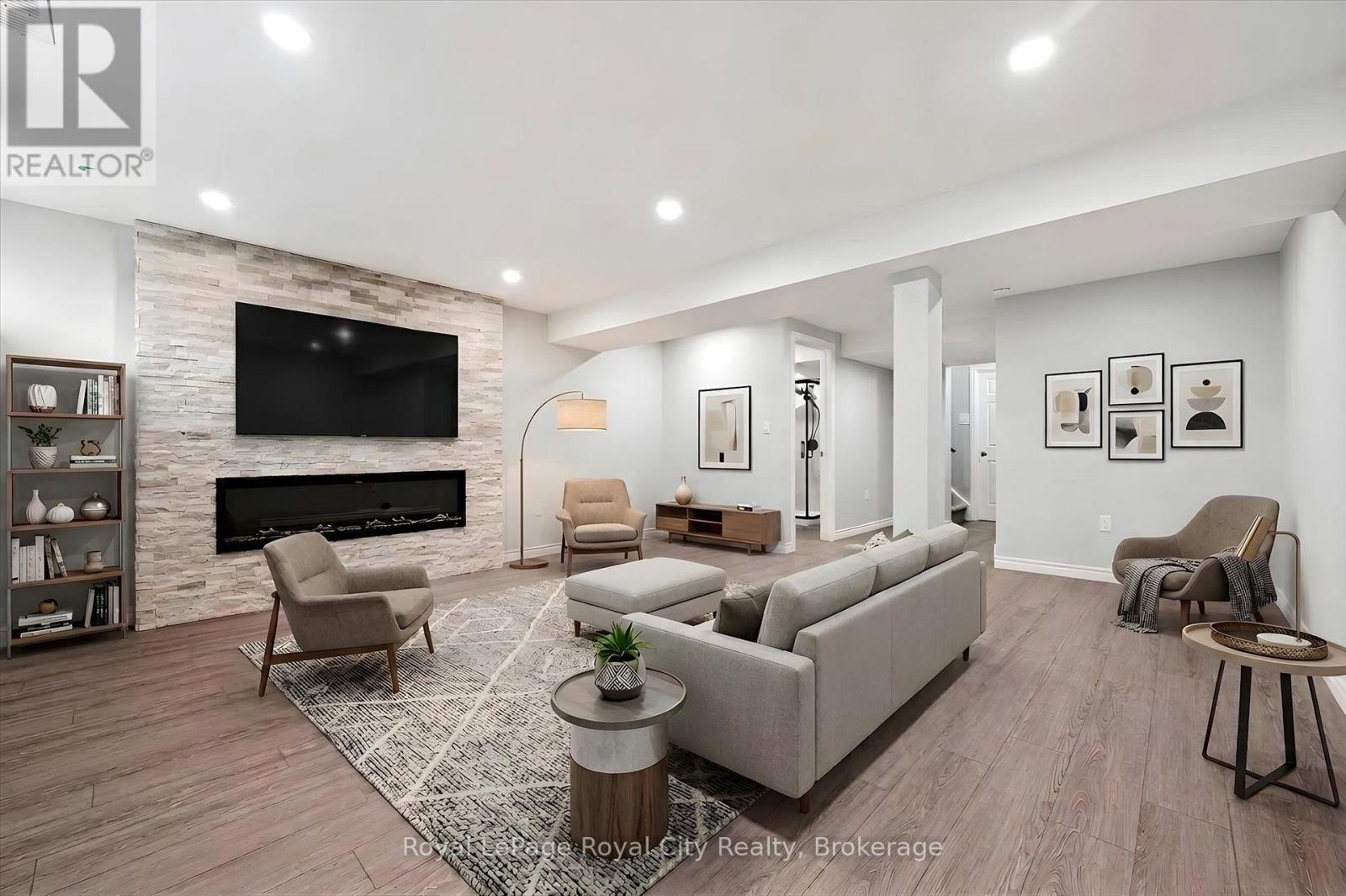 Virtually staged recreation room - 5 Sandybay Avenue, Kitchener, ON - Indoor Photo Showing Living Room With Fireplace