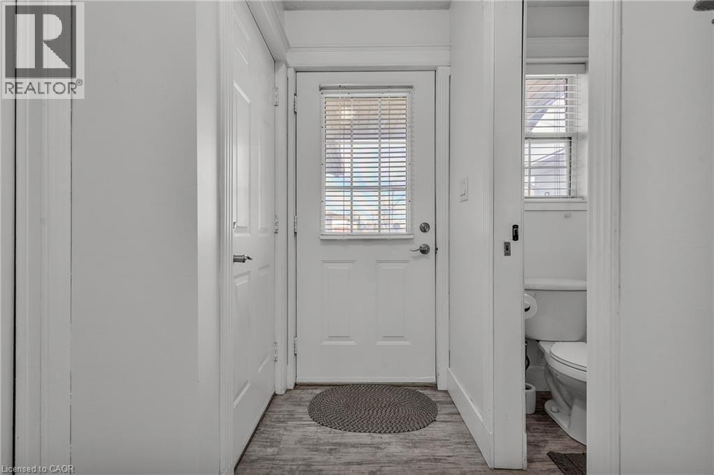 Entryway featuring wood-finish flooring, a paneled door with integrated blinds, and painted trim - 425 Erinbrook Drive, Kitchener, ON - Indoor Photo Showing Other Room
