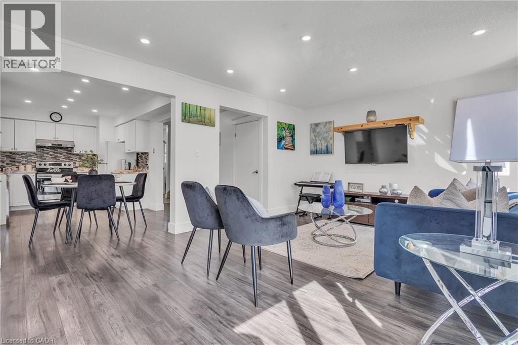 Open-concept living space with wood-finish flooring, recessed lighting, and white trim - 425 Erinbrook Drive, Kitchener, ON - Indoor