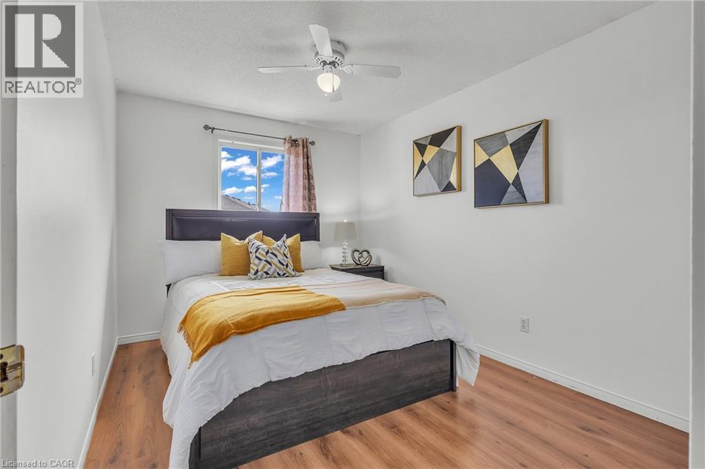 Bedroom featuring wood-finish flooring, a window with natural light, and a ceiling fan with integrated lighting - 425 Erinbrook Drive, Kitchener, ON - Indoor Photo Showing Bedroom