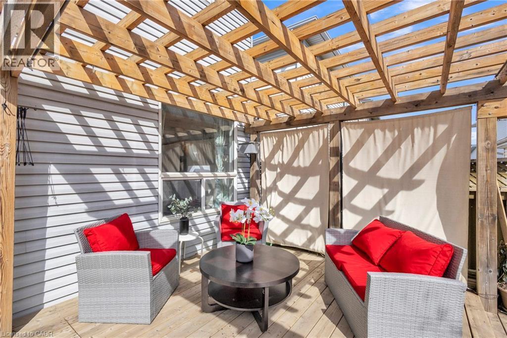 Outdoor deck with a wooden pergola, privacy screens, and exterior siding - 425 Erinbrook Drive, Kitchener, ON - Indoor