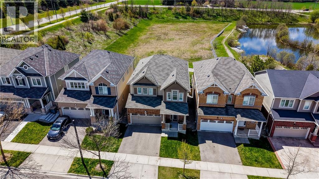 Two-story residence featuring a two-car garage, front porch, and dormer windows - 19 Shoreacres Drive, Kitchener, ON - Outdoor With Facade