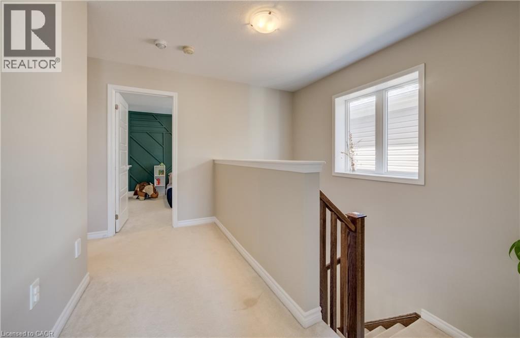 Upper-level hallway featuring a window with horizontal blinds, neutral wall paint, and carpeted flooring - 19 Shoreacres Drive, Kitchener, ON - Indoor Photo Showing Other Room