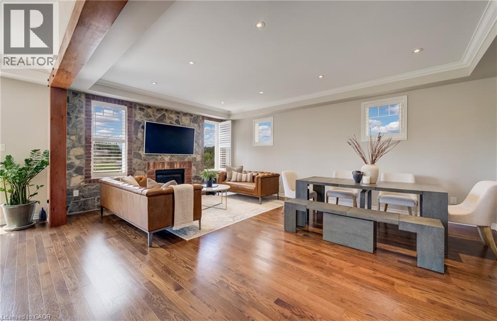 Open-concept living space featuring wood-finish flooring - 19 Shoreacres Drive, Kitchener, ON - Indoor With Fireplace