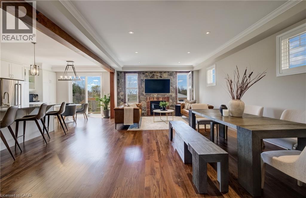 Spacious open concept living area featuring wood-finish flooring, recessed lighting, and crown molding - 19 Shoreacres Drive, Kitchener, ON - Indoor