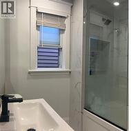 Bathroom featuring a shower and sink -
