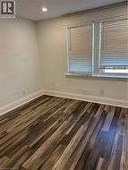 Unfurnished room with dark hardwood / wood-style floors -