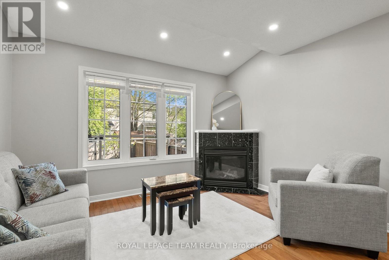 40 Milner Downs Crescent, Ottawa, ON - Indoor Photo Showing Living Room With Fireplace