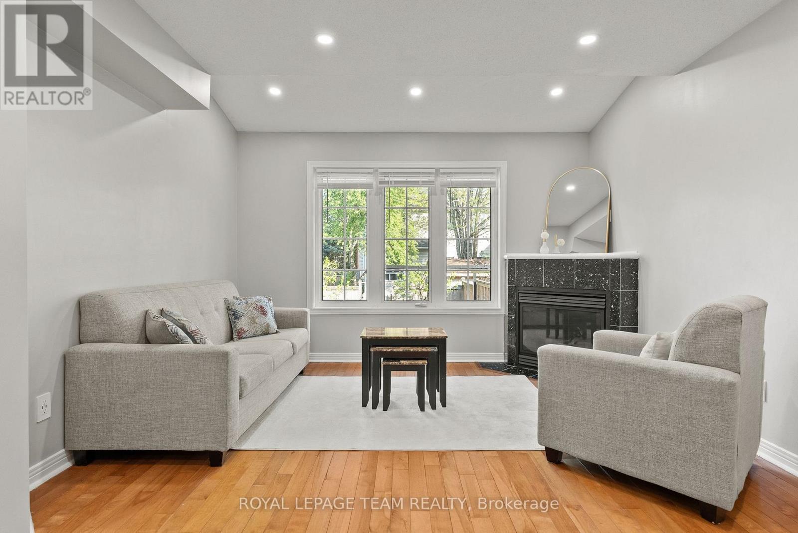 40 Milner Downs Crescent, Ottawa, ON - Indoor Photo Showing Living Room With Fireplace