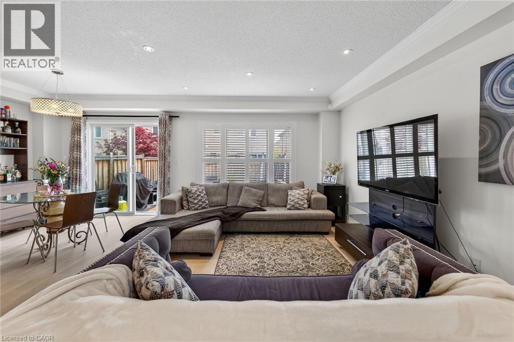 Open-concept living area with light wood-finish flooring, recessed lighting, and crown molding - 4236 Prudham Avenue, Burlington, ON - Indoor Photo Showing Living Room