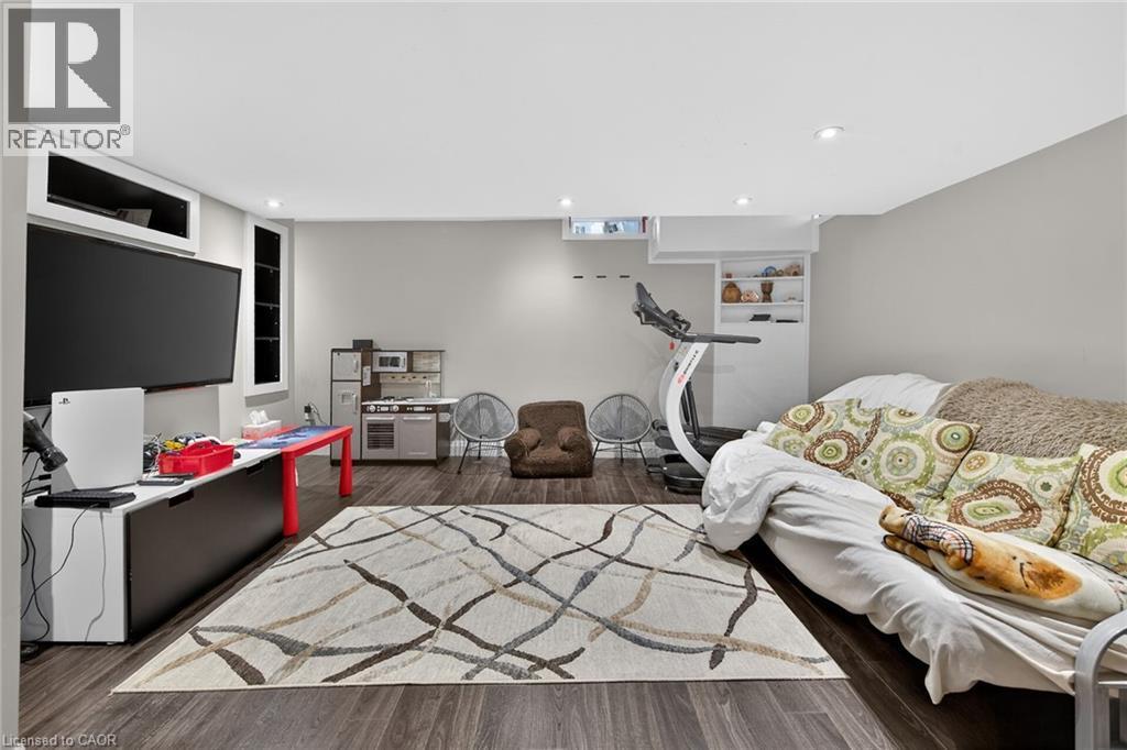 Finished lower-level space featuring recessed lighting and wood-finish flooring - 4236 Prudham Avenue, Burlington, ON - Indoor