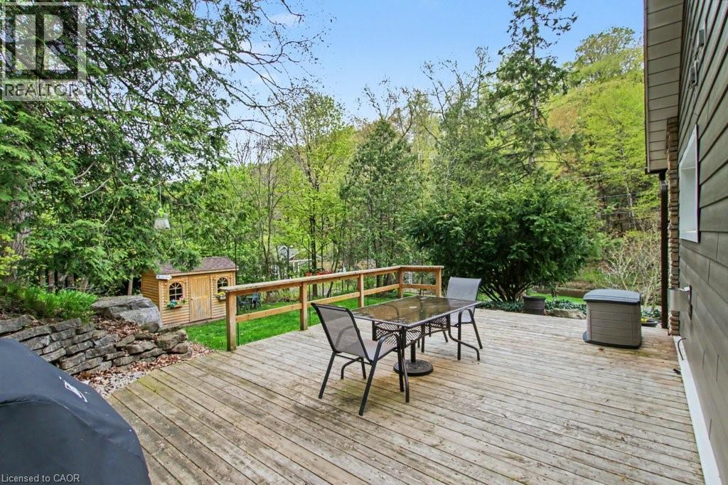Expansive wood-plank deck with a wooden railing, surrounded by mature trees - 1333 Hidden Valley Road, Burlington, ON - Outdoor With Deck Patio Veranda