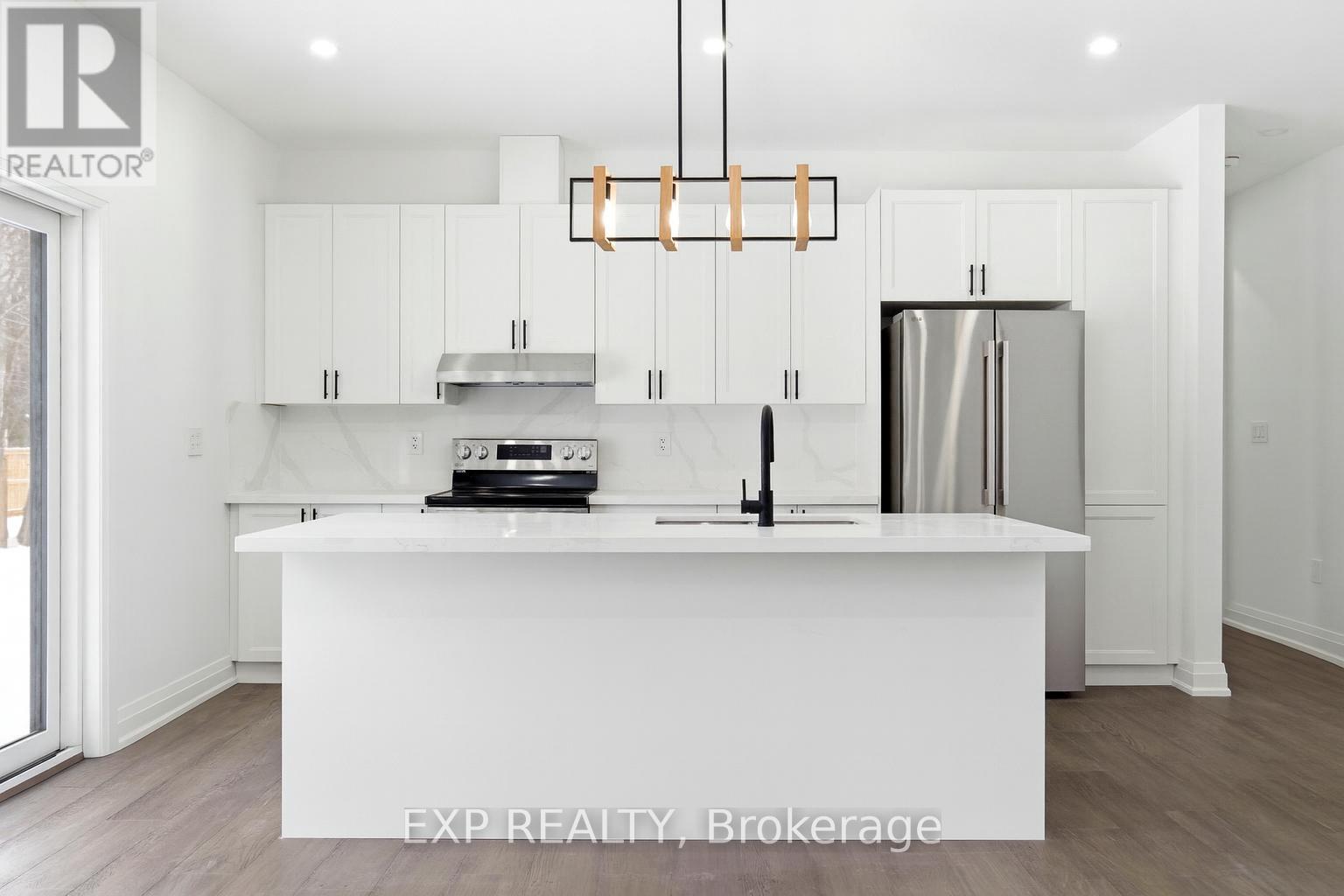 Kitchen with sit-up island, sink & b/i dishwasher - 49 Beaufort Crescent, Tiny, ON - Indoor Photo Showing Kitchen