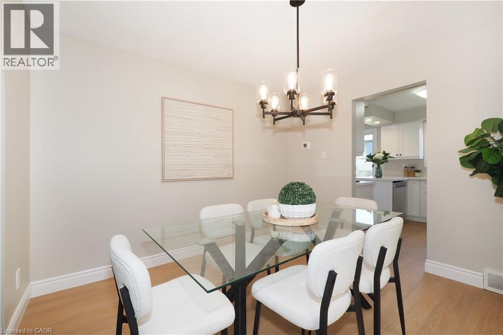 Dining area with light-toned walls and wood-finish flooring - 27 Scenic Wood Crescent, Kitchener, ON - Indoor Photo Showing Dining Room