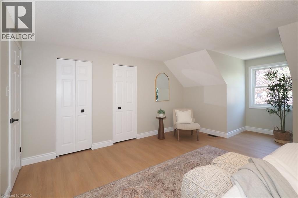 Light wood-finish flooring with white baseboards throughout - 27 Scenic Wood Crescent, Kitchener, ON - Indoor Photo Showing Bedroom