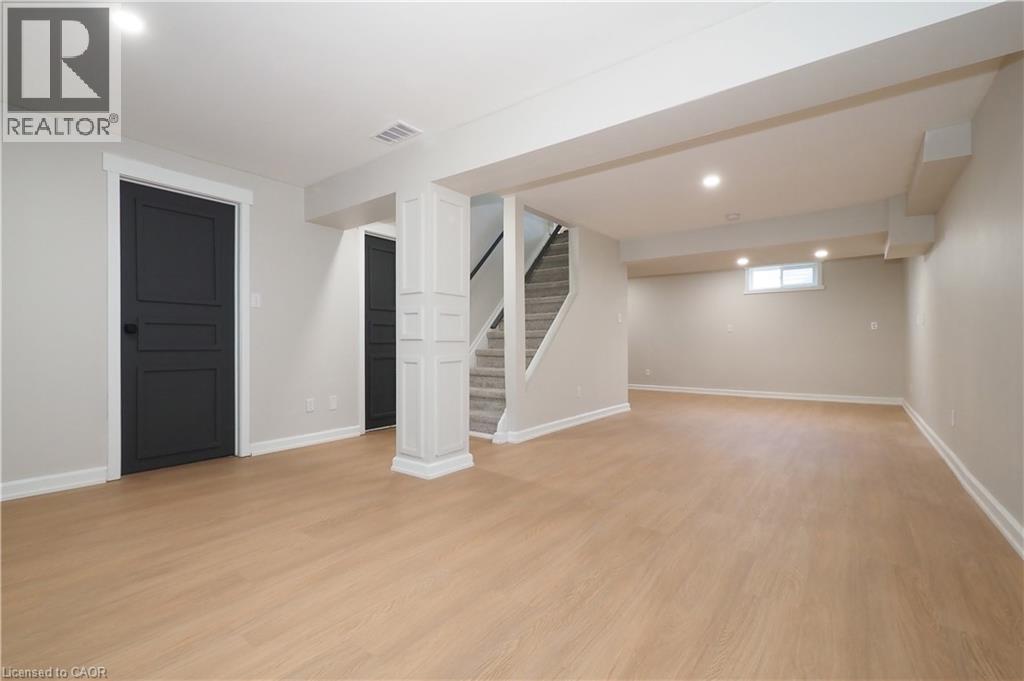 Spacious lower level featuring light wood-finish flooring and recessed lighting - 27 Scenic Wood Crescent, Kitchener, ON - Indoor