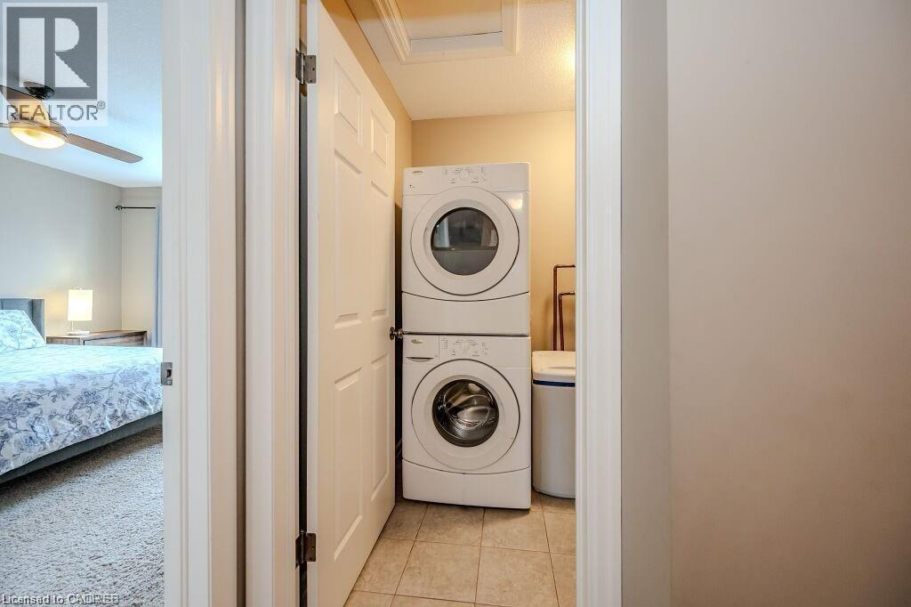 Dedicated laundry area featuring a stacked washer and dryer unit - 275 Old Huron Road Unit# 21, Kitchener, ON - Indoor Photo Showing Laundry Room