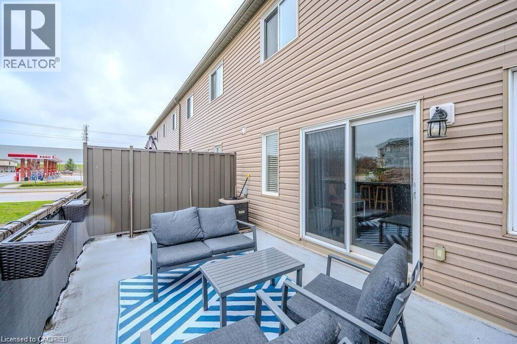 Patio area featuring concrete flooring and a privacy fence - 275 Old Huron Road Unit# 21, Kitchener, ON - Outdoor With Deck Patio Veranda With Exterior
