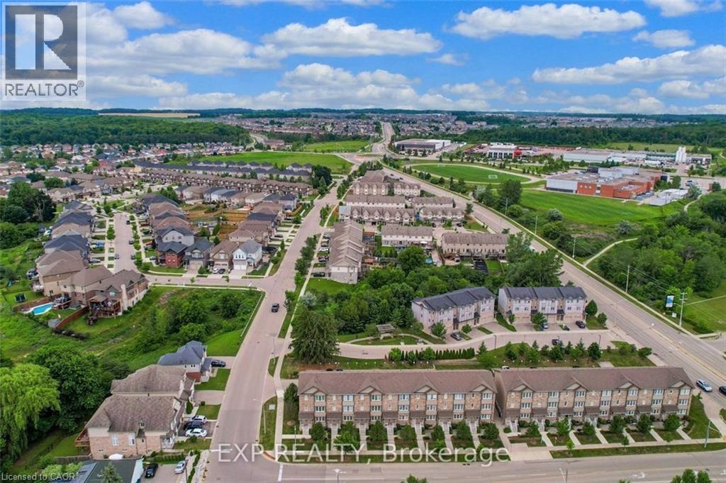 Expansive aerial showcasing a residential neighborhood with a mix of detached homes and townhouses - 275 Old Huron Road Unit# 21, Kitchener, ON - Outdoor With View