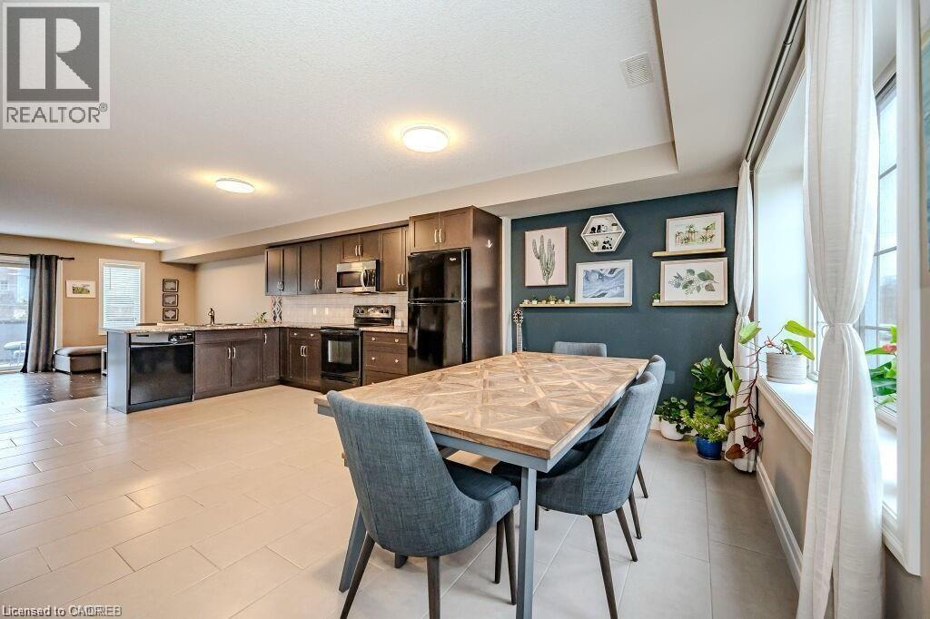Open-concept kitchen and dining area with light-toned tile flooring - 275 Old Huron Road Unit# 21, Kitchener, ON - Indoor