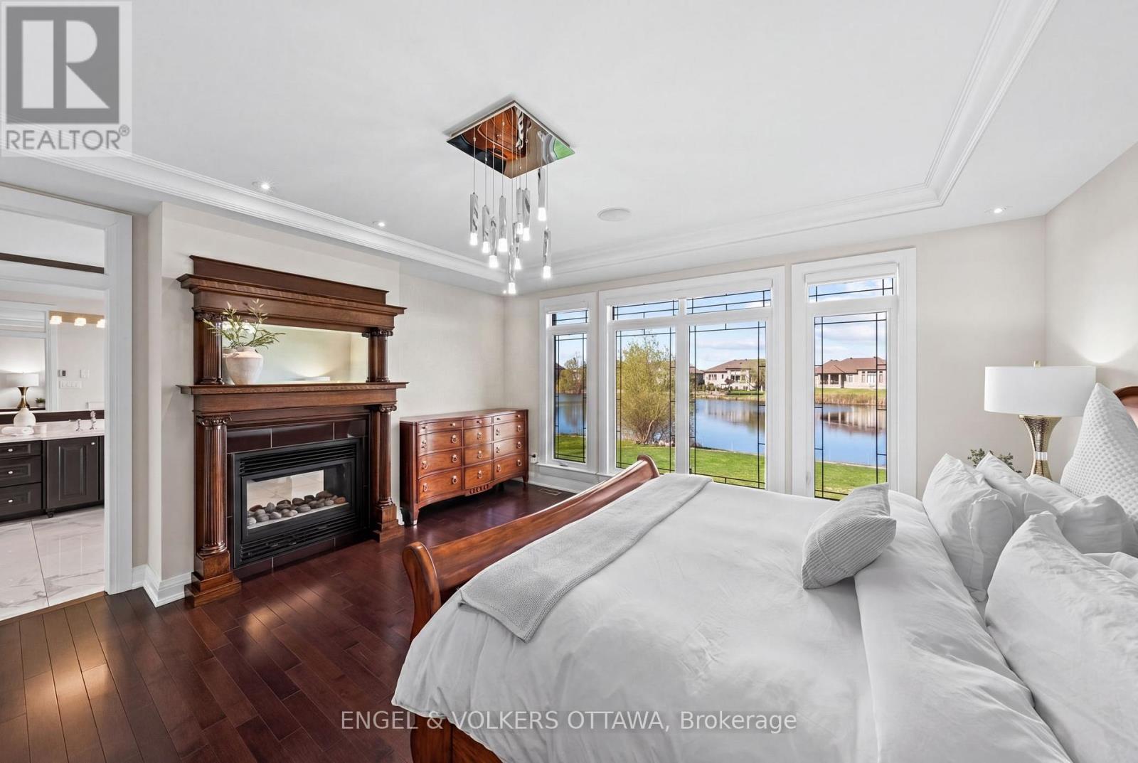 Primary Bedroom - 1457 Waters Edge Way, Ottawa, ON - Indoor Photo Showing Bedroom With Fireplace