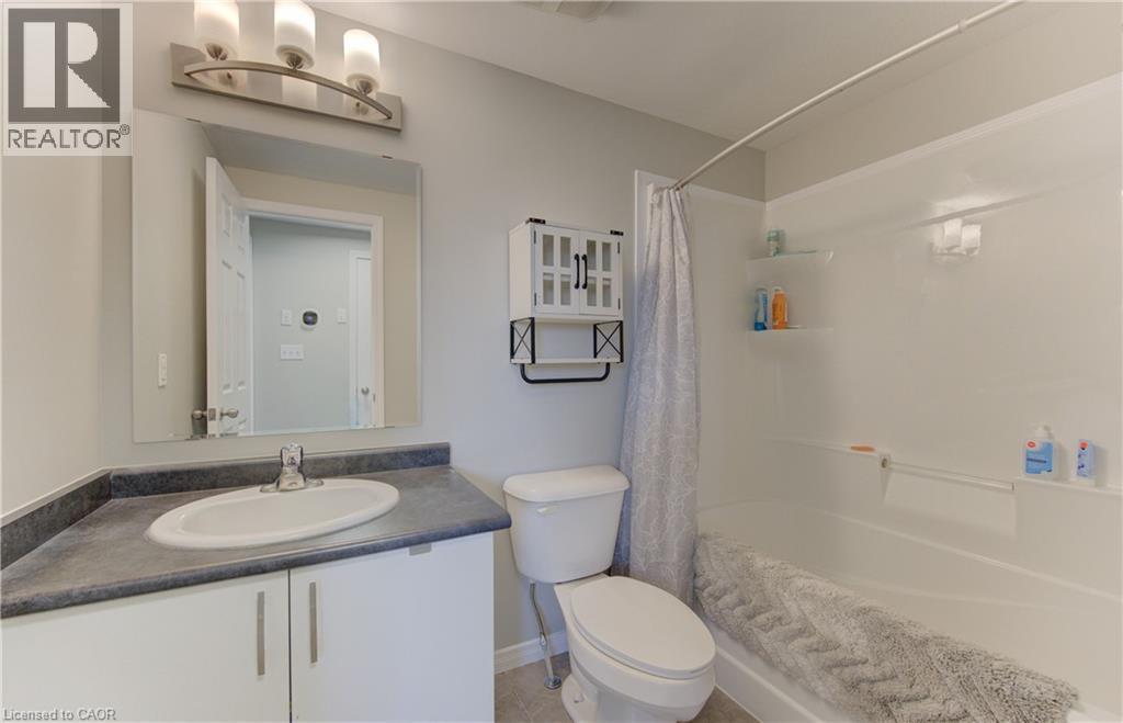 Bathroom featuring a single vanity with gray countertop, white cabinetry, and an oval undermount sink - 388 Old Huron Road Unit# 24A, Kitchener, ON - Indoor Photo Showing Bathroom
