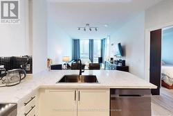 KITCHEN IS OVERLOOKING THE LIVING ROOM AREA -