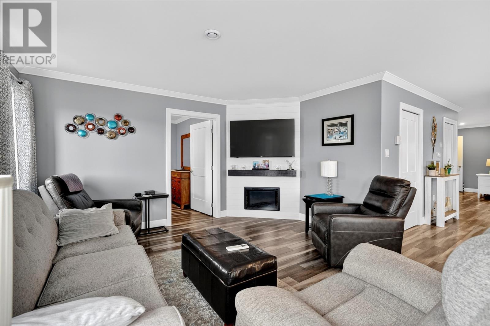 ground level in-law suite - 46 Remembrance Loop, Carbonear, NL - Indoor Photo Showing Living Room With Fireplace
