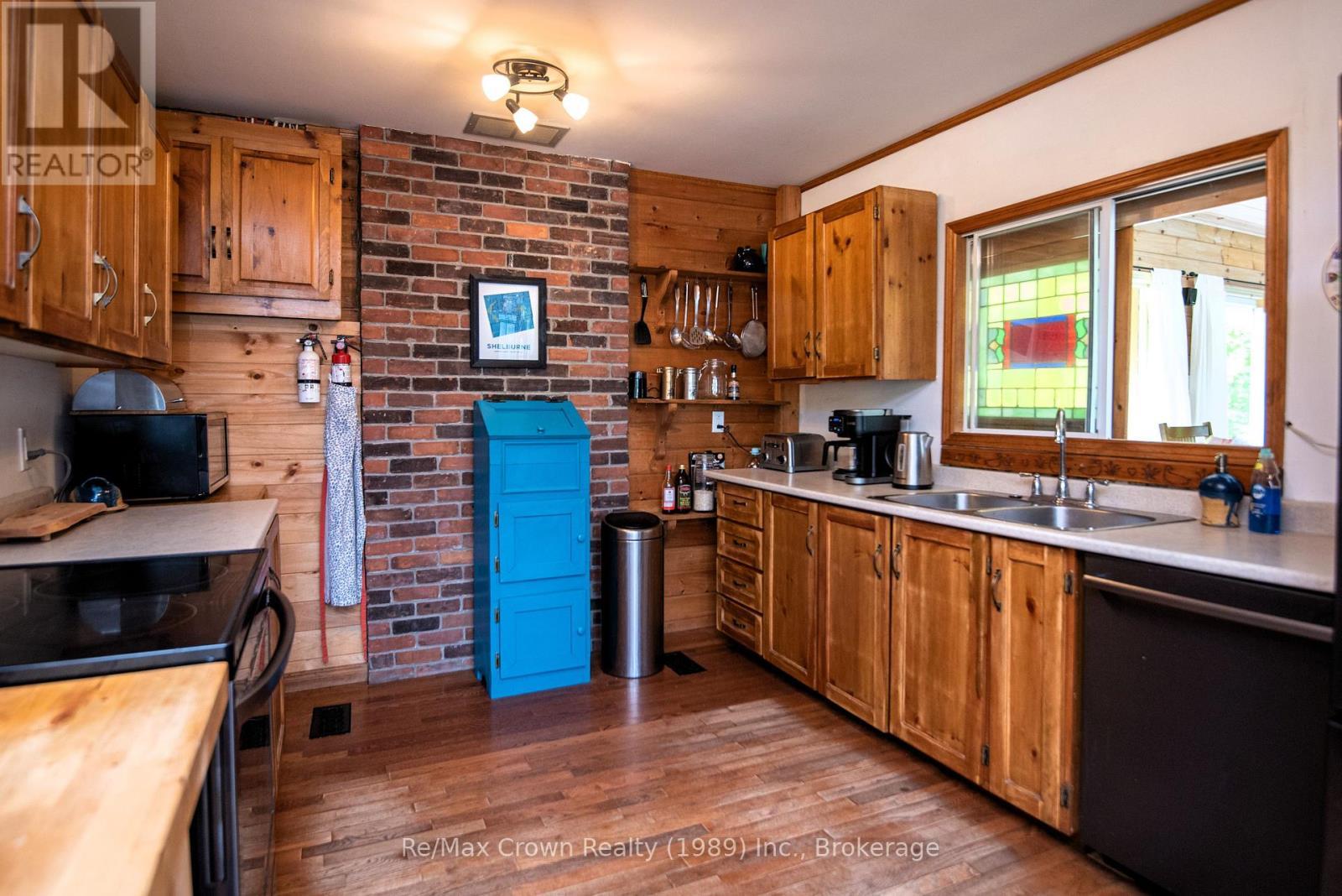 Kitchen w/pass throughwindow to Dining area - 294 Everett Drive, Parry Sound Remote Area (Restoule), ON - Indoor Photo Showing Kitchen With Fireplace With Double Sink