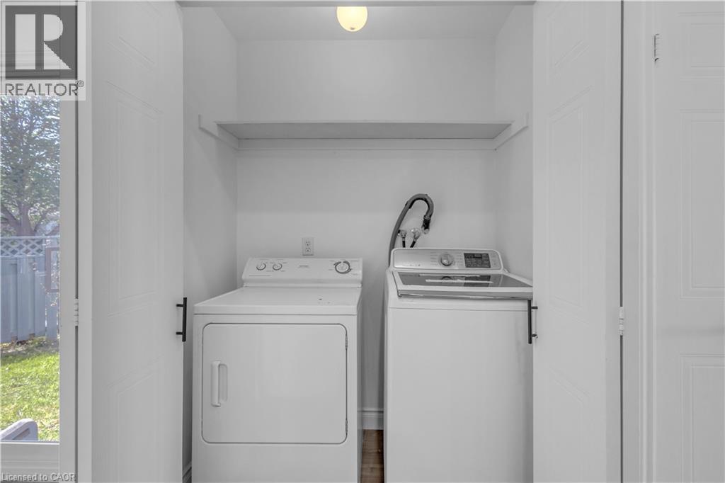 Dedicated laundry area featuring a shelf, overhead lighting, and white bi-fold doors - 375 Silverbirch Boulevard, Hamilton, ON - Indoor Photo Showing Laundry Room