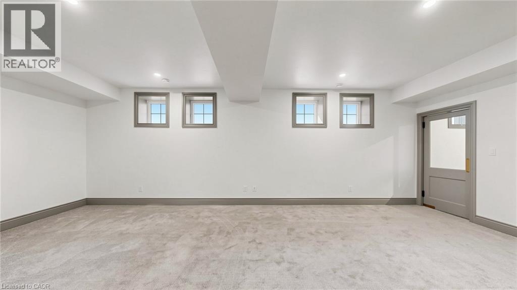 Spacious room featuring light-colored carpeting, white walls, and recessed lighting - 41 Talbot Road, Delhi, ON - Indoor Photo Showing Other Room