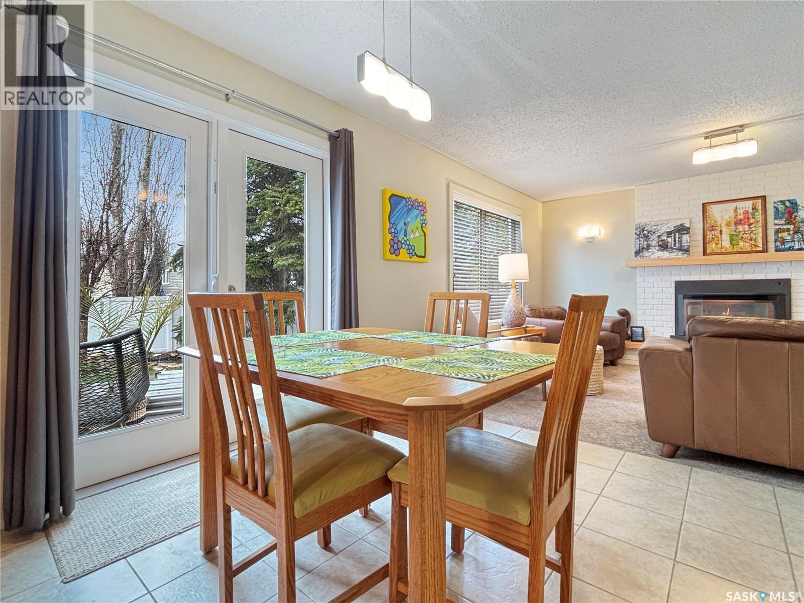 355 Ball Crescent, Saskatoon, SK - Indoor Photo Showing Dining Room With Fireplace