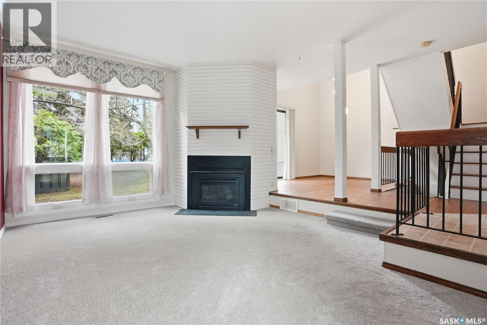 20 455 Pinehouse Drive, Saskatoon, SK - Indoor Photo Showing Living Room With Fireplace