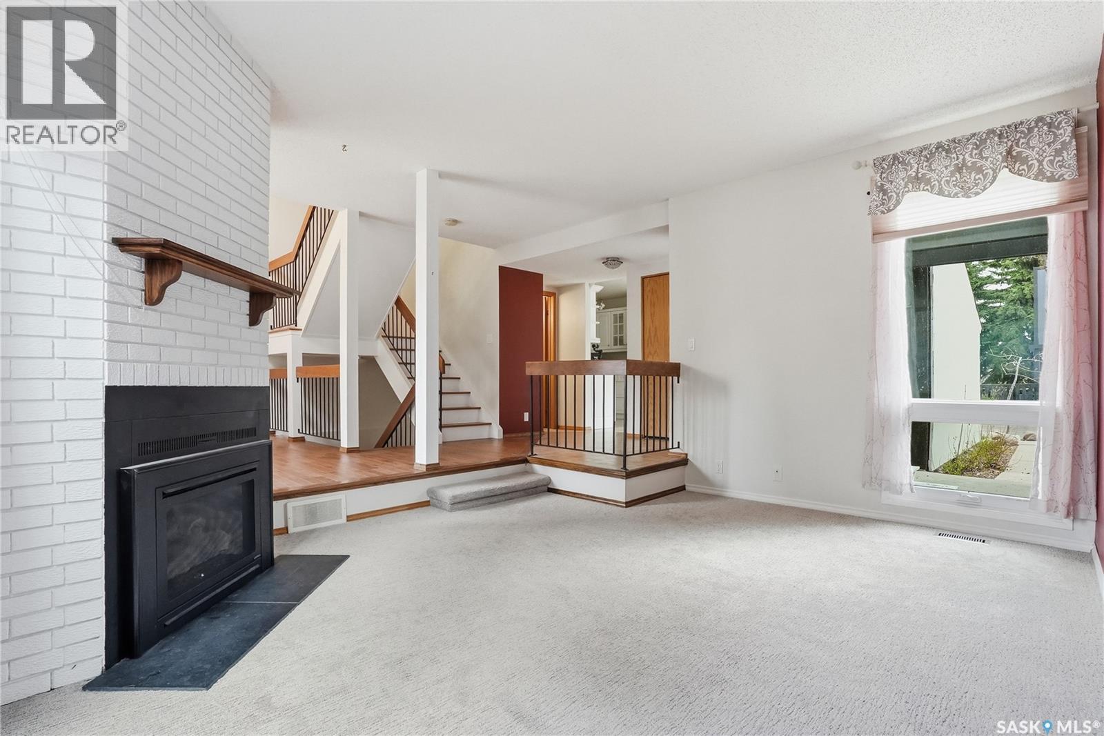 20 455 Pinehouse Drive, Saskatoon, SK - Indoor With Fireplace