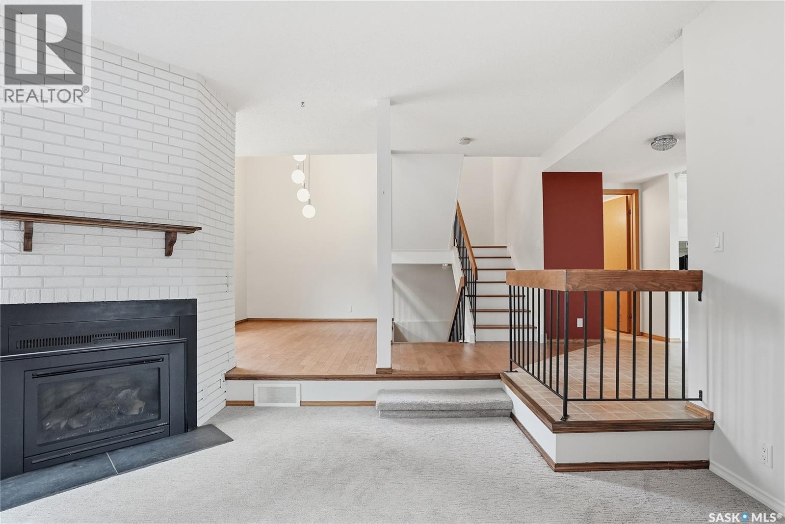 20 455 Pinehouse Drive, Saskatoon, SK - Indoor Photo Showing Living Room With Fireplace