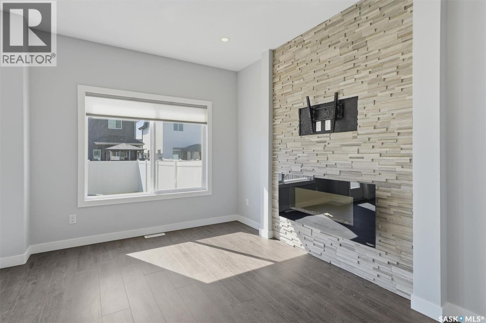 348 Brighton Gate, Saskatoon, SK - Indoor Photo Showing Living Room With Fireplace