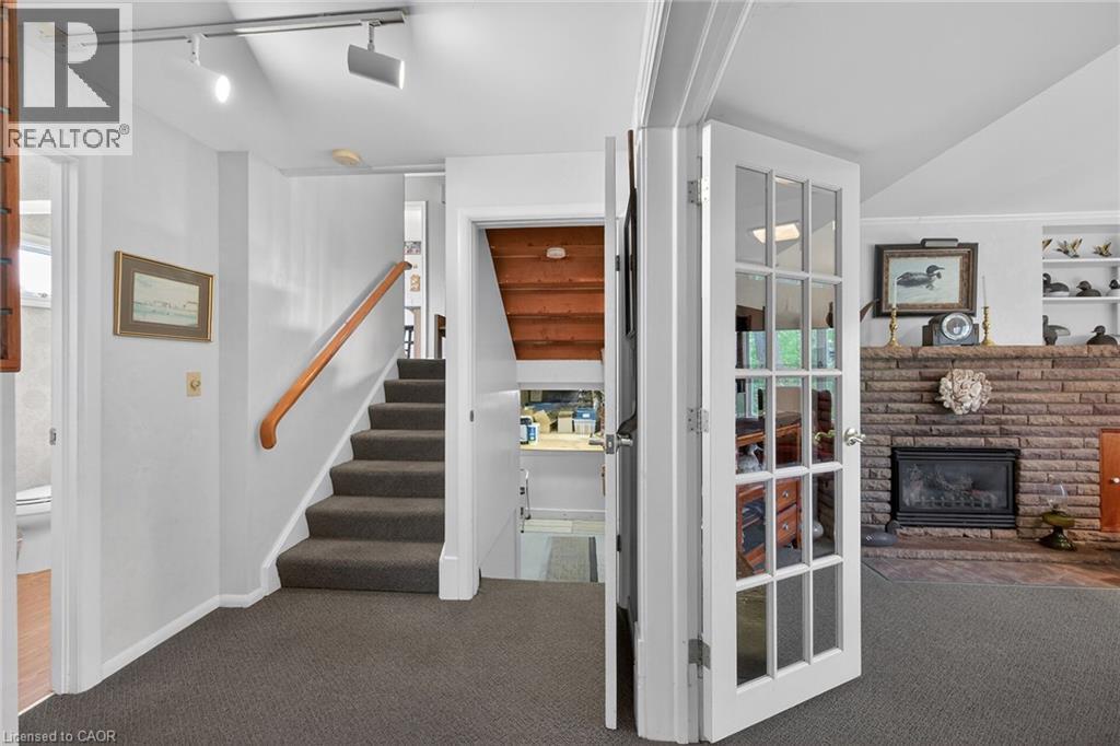 Interior entryway featuring carpeted flooring and white trim - 2 Summit Circle, Simcoe, ON - Indoor Photo Showing Other Room With Fireplace