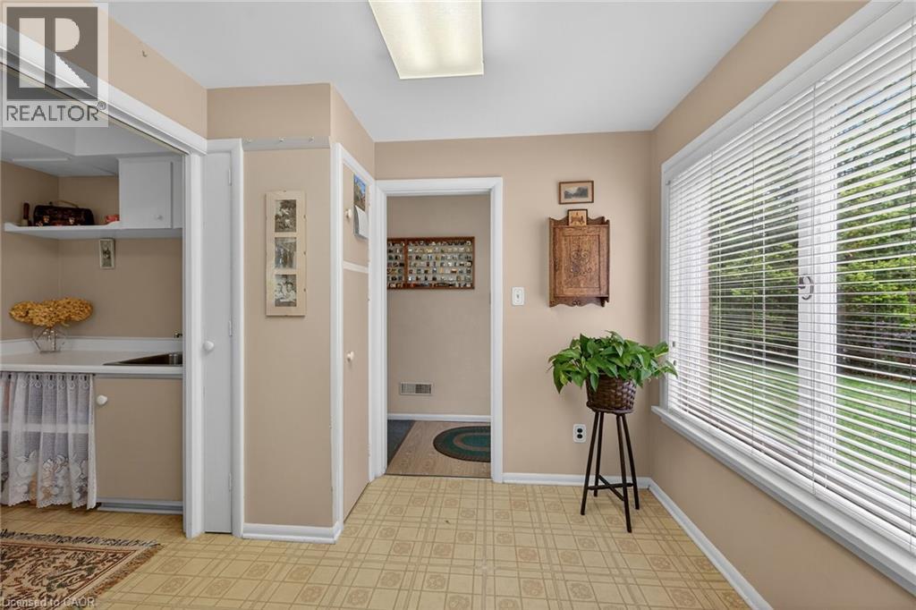 Spacious room with patterned vinyl flooring and neutral wall tones - 2 Summit Circle, Simcoe, ON - Indoor Photo Showing Other Room