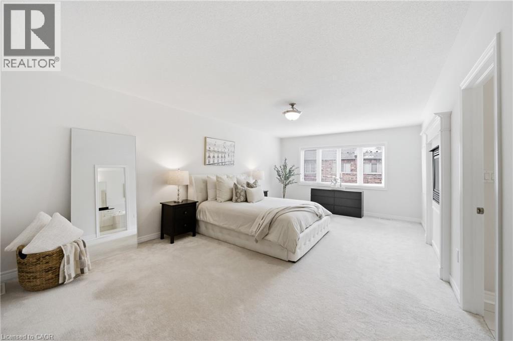 Spacious room featuring light-toned carpeting, a window providing natural light, a built-in media cabinet, and a flush-mount ceiling light fixture - 2466 Village Common, Oakville, ON - Indoor Photo Showing Bedroom