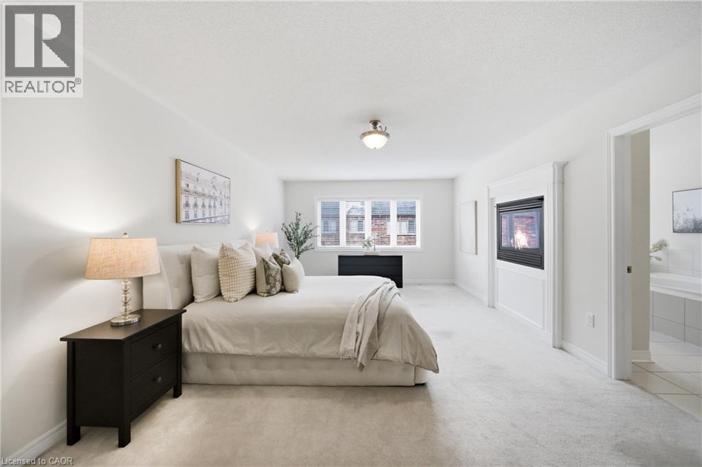 Spacious room featuring a built-in fireplace, crown molding, and light-toned carpeting - 2466 Village Common, Oakville, ON - Indoor Photo Showing Bedroom