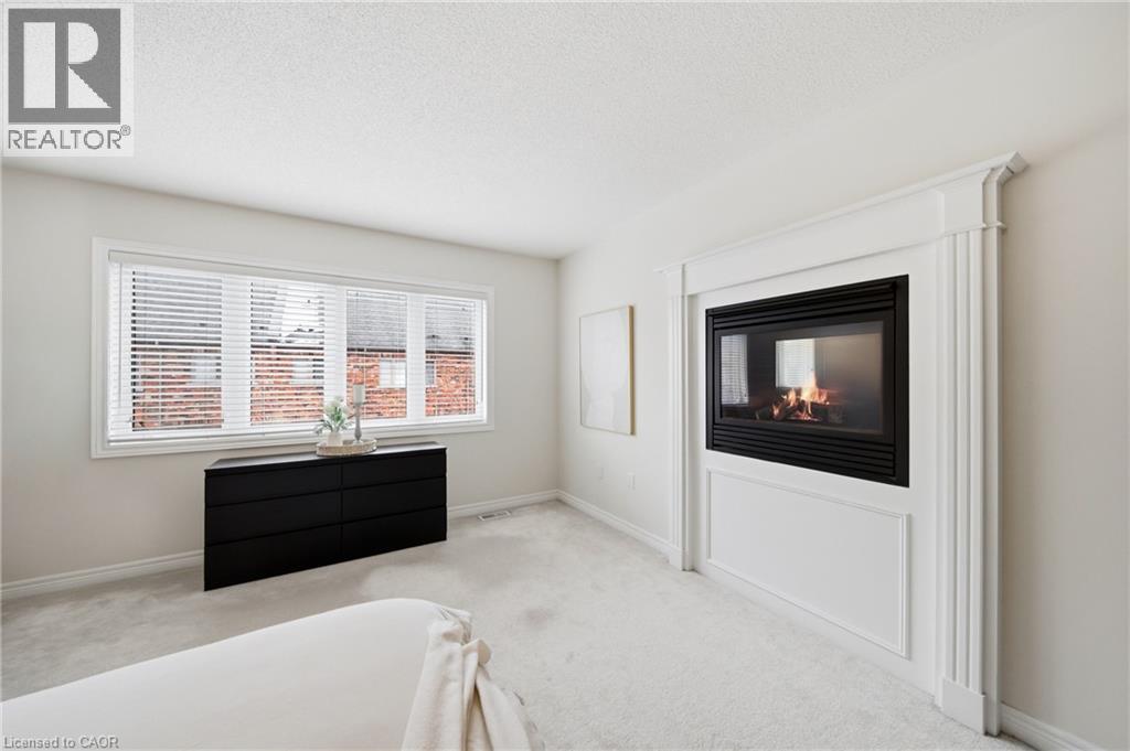 Wall-mounted fireplace with ornate white trim and mantel - 2466 Village Common, Oakville, ON - Indoor