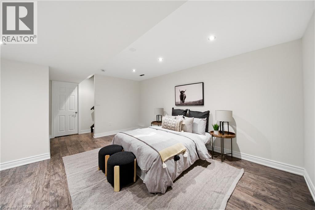 Spacious room featuring wood-finish flooring, recessed lighting, and white baseboards - 2466 Village Common, Oakville, ON - Indoor Photo Showing Bedroom