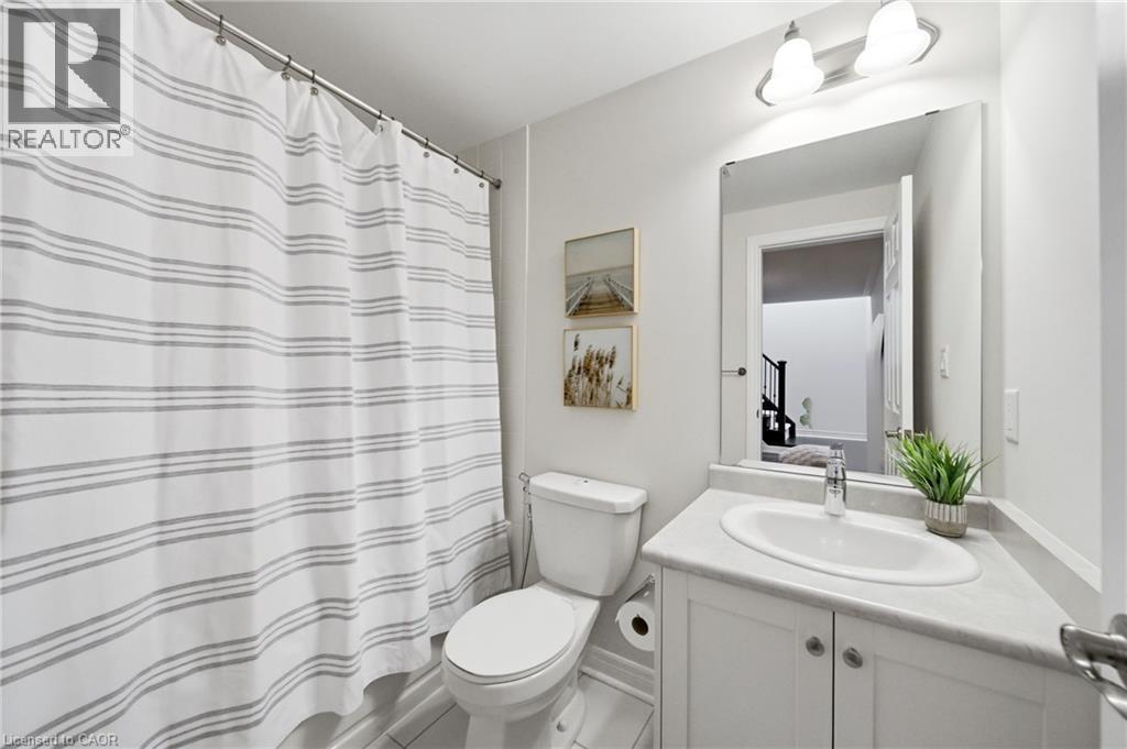 Bathroom featuring a white vanity with an integrated sink, polished chrome faucet, and a large mirror - 2466 Village Common, Oakville, ON - Indoor Photo Showing Bathroom