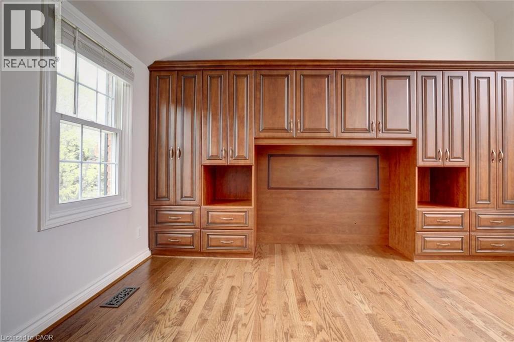 Integrated cabinetry system featuring rich wood finishes, diverse storage options, and polished hardware - 463 Blathwayte Lane, Burlington, ON - Indoor Photo Showing Other Room