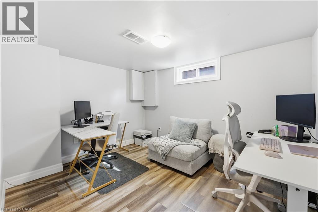 Versatile room featuring wood-finish flooring, light grey walls, and a recessed window - 168 Nugent Drive, Hamilton, ON - Indoor Photo Showing Office