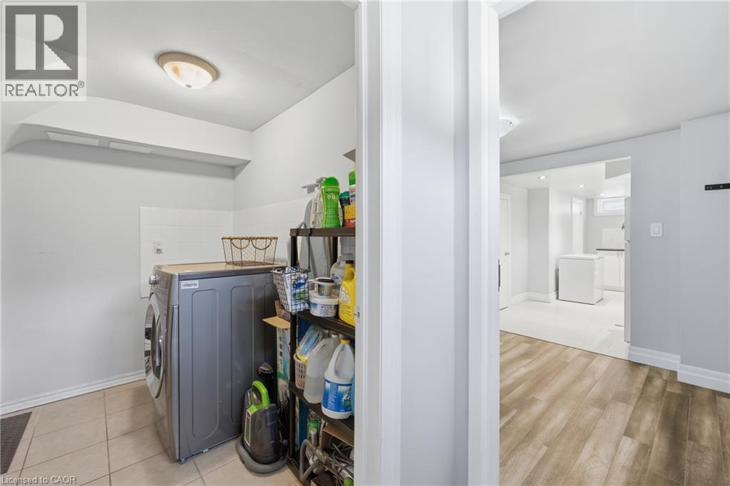 Dedicated laundry area featuring tile flooring and a neutral color palette - 168 Nugent Drive, Hamilton, ON - Indoor Photo Showing Laundry Room